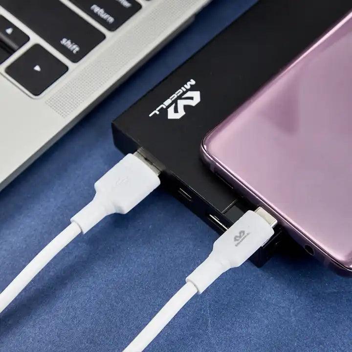 cable data Miccell al lado de laptop